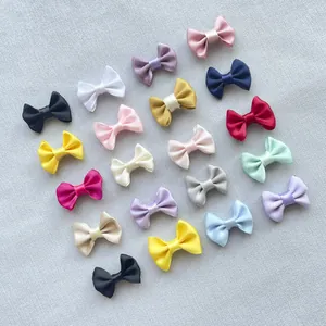Macro shot of colorful 3cm mini satin ribbon bows for DIY hair accessories and clothing