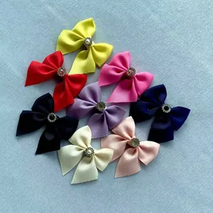 Close-up of assorted colorful grosgrain ribbon bows with elegant pearl and rhinestone centers