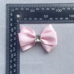 Pink satin bow with a rectangular crystal centerpiece for DIY hair accessories and decor