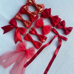 Detailed collection of red handmade DIY bow accessories in satin, lace and mesh fabrics