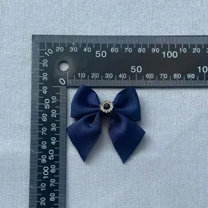 Macro shot of 5cm navy blue grosgrain ribbon bow with a center rhinestone embellishment