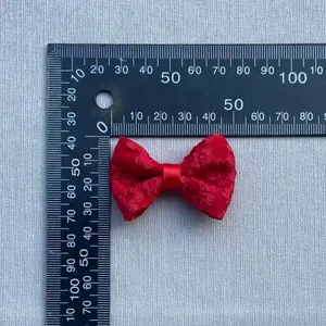 Detail view of 50mm red lace bow with measurement ruler for DIY hair accessories
