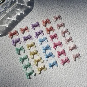 Macro view of 1cm satin ribbon bows in macaron colors for DIY doll clothing and crafts