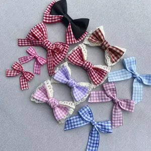 Detail view of colorful plaid gingham bows with lace trim for DIY garment accessories