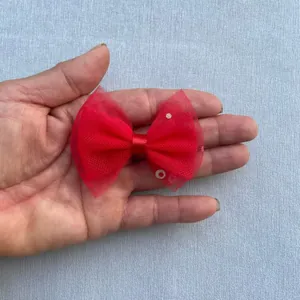 Macro shot of red mesh butterfly bow with sequins for DIY accessories and hair clips