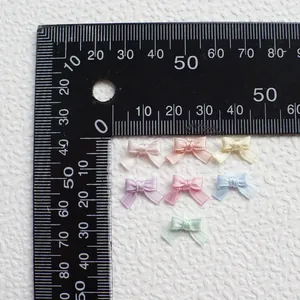 Detailed macro view of multi-color 1.5cm mini satin ribbon bows for DIY doll clothing