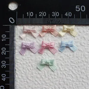 Detailed view of 1cm mini satin bows in 7 pastel colors for DIY craft and doll clothes