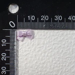 Miniature light purple satin ribbon bows measuring 15mm for handmade DIY doll clothing crafts
