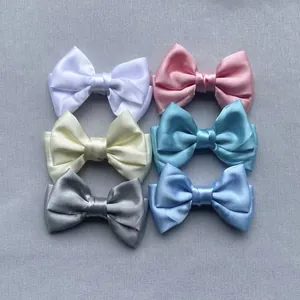 Close-up of double-layer satin bows in six assorted colors for DIY hair accessories