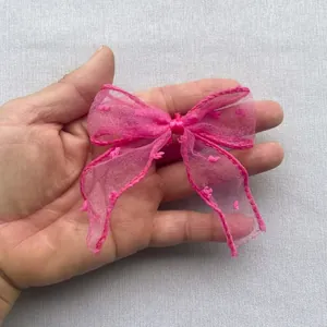 Détail d'un nœud en résille rose fait main avec points 3D pour accessoires de coiffure