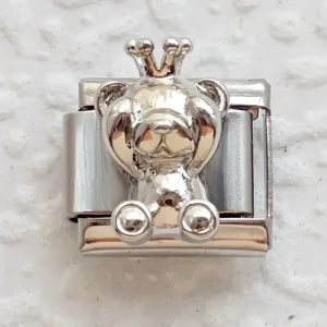 Macro detail of silver stainless steel Italian charm featuring a 3D crown bear relief