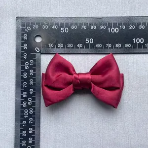 Burgundy satin double bow decoration 8.5cm wide with ruler showing dimensions
