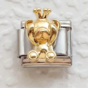 Detail of Italian charm link featuring 3D golden teddy bear with crown on stainless steel base