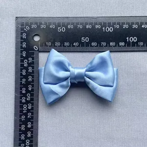 Close-up of 80mm light blue satin double-layered bow ornament showing precise dimensions