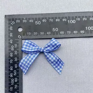 Close-up of blue gingham ribbon bow with 45mm width for DIY garment and hair accessory