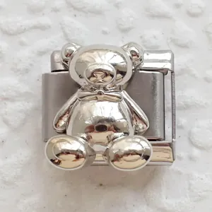 Macro shot of a 3D teddy bear charm link in polished silver stainless steel for DIY bracelets