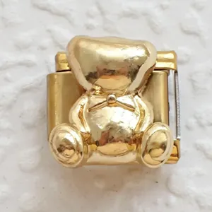 Macro shot of 3D golden teddy bear Italian charm link with polished finish for DIY bracelets