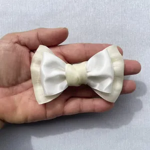 Close-up of Morandi color layered bow accessory made of satin and textured fabric