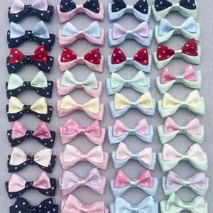 Close-up of assorted double-layer polka dot bow hair clips in various vibrant colors