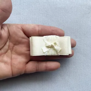 Macrodetail van een crème dubbellaagse strik van kant en satijn voor Lolita-accessoires