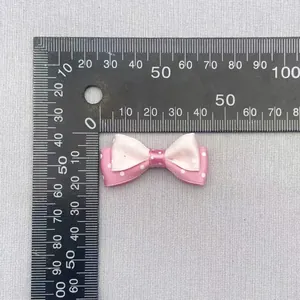 Detailed view of pink polka dot double-layer bow with ruler measurement 35mm wide