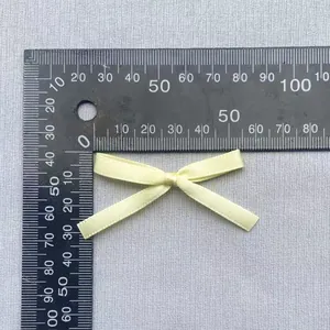 Detaillierte Messung der kleinen cremefarbenen Bandschleife mit 4,5 cm Breite