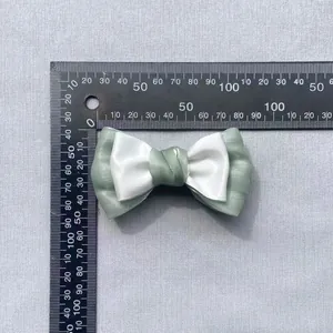 Detailed view of mint green and white ribbon bow with measurements showing 7.5cm width