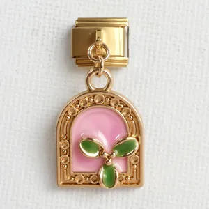 Makroaufnahme von italienischem Gold-Charm mit rosa Emaille und grünem Blatt-Design
