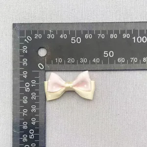 Close-up of 4cm double-layered polka dot bow with ruler showing exact size detail