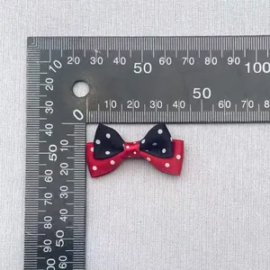 Detail of 35mm red and black polka dot double-layer satin bow accessory for DIY crafts