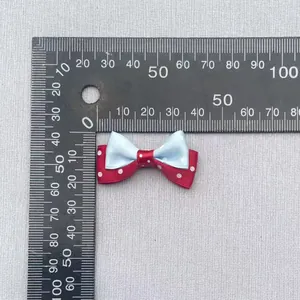 Measurement of small double-layered polka dot bow showing dimensions of 35mm by 25mm