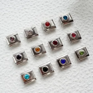 Macro shot of 12 stainless steel Italian charms with colorful assorted birthstones