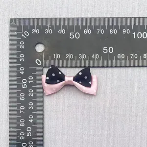 Detail view of a 35mm double-layer polka dot bow with ruler measuring dimensions
