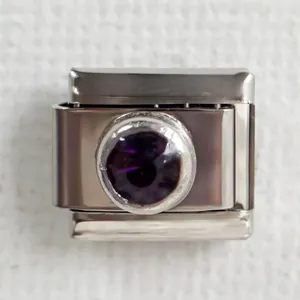 Detail of Italian charm bracelet link in stainless steel with faceted purple gemstone