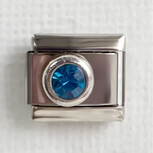 Italian charm bracelet module in silver steel with a faceted blue round gemstone charm