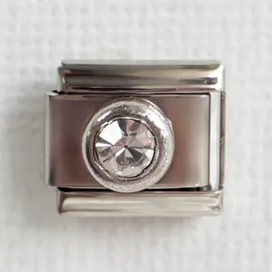 Close-up of Italian charm link with round clear crystal on stainless steel base