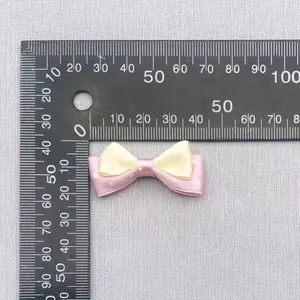 Detail shot showing a 4cm double-layer polka dot bow accessory next to a ruler scale