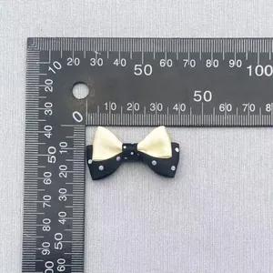 Detailed view of a 33mm double-layered polka dot bow with size scale for DIY accessories