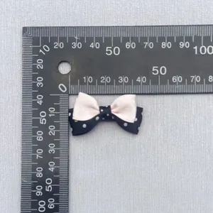 Detail view of a 4cm double-layered polka dot and pink satin bow DIY accessory