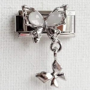 Detailed macro view of butterfly charm link with opal inlay for Italian modular bracelet