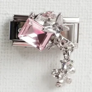 Detail of Italian charm with pink crystal, metal butterfly and dangling tassel chain