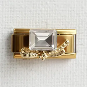 Macro detail of Italian charm link featuring a crystal stone and golden butterfly bow