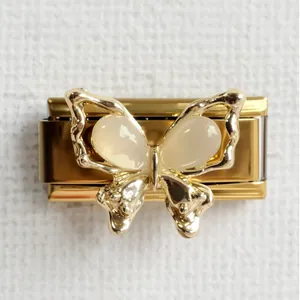 Macro detail of golden butterfly modular charm with opal-style inlay for Italian bracelet