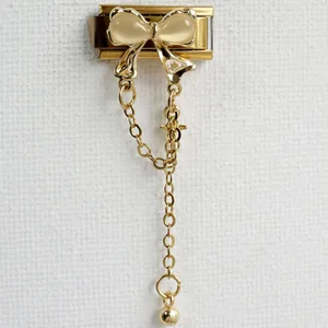 Detailed view of Italian charm link featuring a golden butterfly and dangling chains