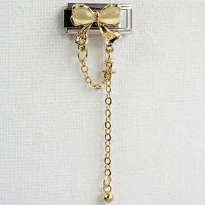 Detailed close-up of a golden butterfly charm with dangling tassels for Italian link bracelets