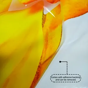 Close-up of translucent sunflower wall sticker with adhesive backing being peeled off