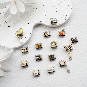 Macro view of stainless steel Italian charm links with colorful musical and star motifs