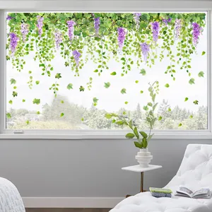 Detail of hanging wisteria flower window clings showing purple blooms and green leaves