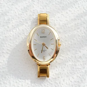 Macro view of gold quartz watch dial with silver sunray pattern and metal markers