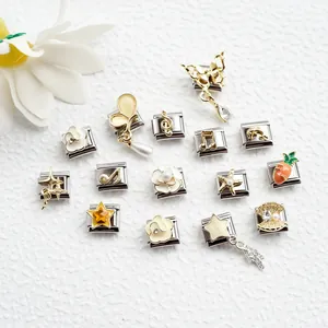 Detailed macro view of stainless steel Italian charms with butterfly and star designs